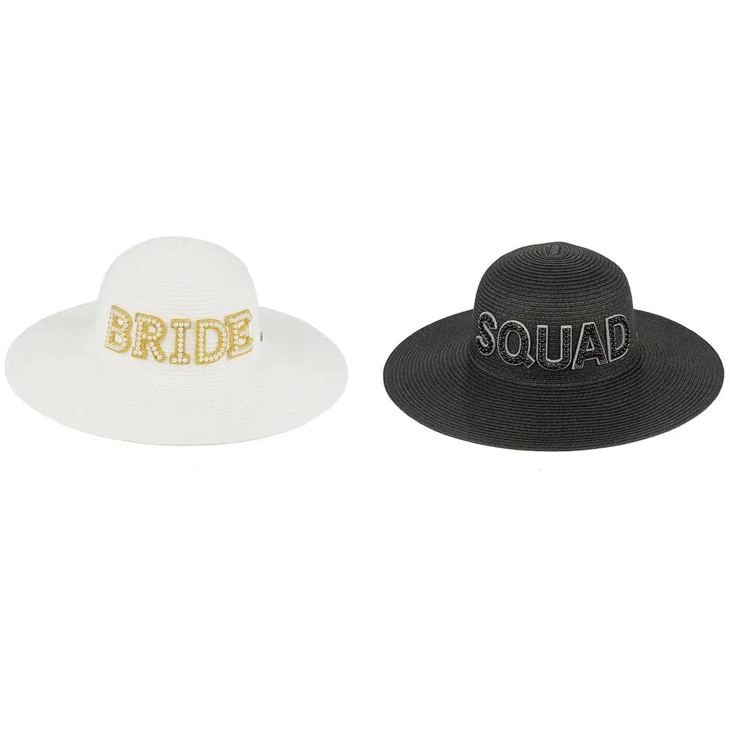 Two wide-brimmed straw-style hats shown side by side on a white background with text labels below. The left hat is white with 'BRIDE' in gold glitter lettering and is labeled 'BRIDE-WHITE'.