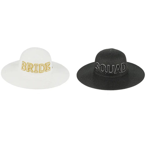Two wide-brimmed straw-style hats shown side by side on a white background with text labels below. The left hat is white with 'BRIDE' in gold glitter lettering and is labeled 'BRIDE-WHITE'.