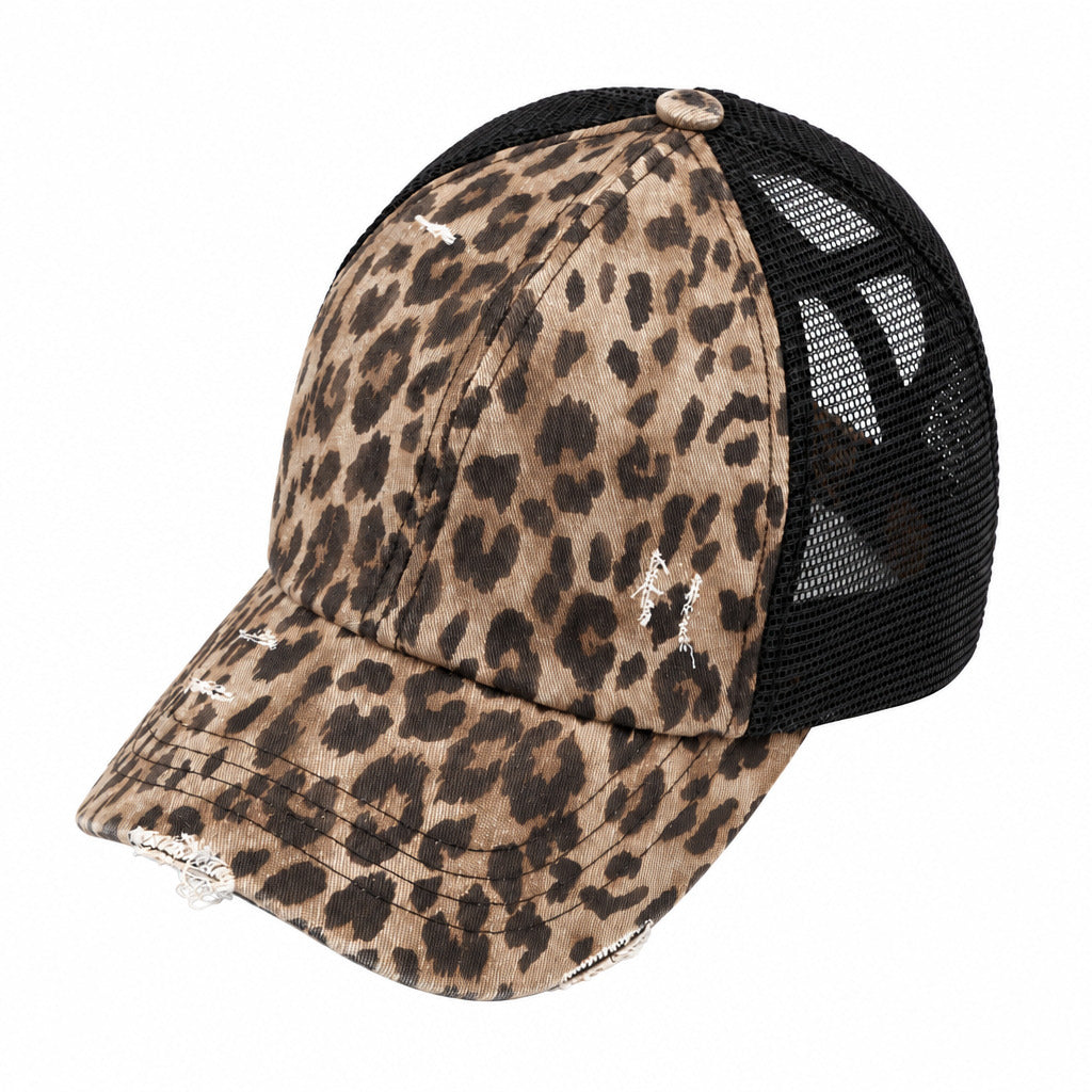 A distressed trucker-style baseball cap featuring a leopard print pattern on the front panels and brim, with a black mesh back.