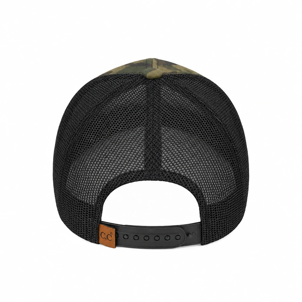 Back view of a trucker hat with a black mesh back, olive green camouflage front panels, and a black adjustable snap strap with a small brown leather patch.