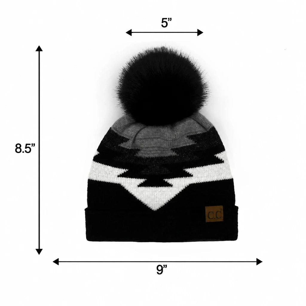 A black, gray, and white knit beanie with a large black pom-pom, shown with dimension arrows and labels.